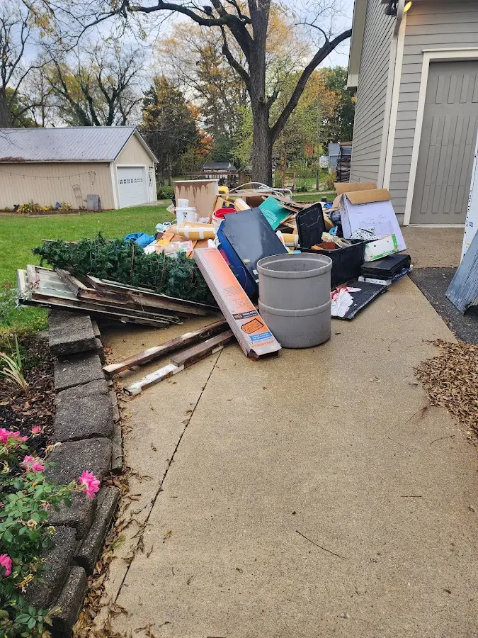 Dumpster being loaded with debris for Commercial Dumpster Rental in Troy